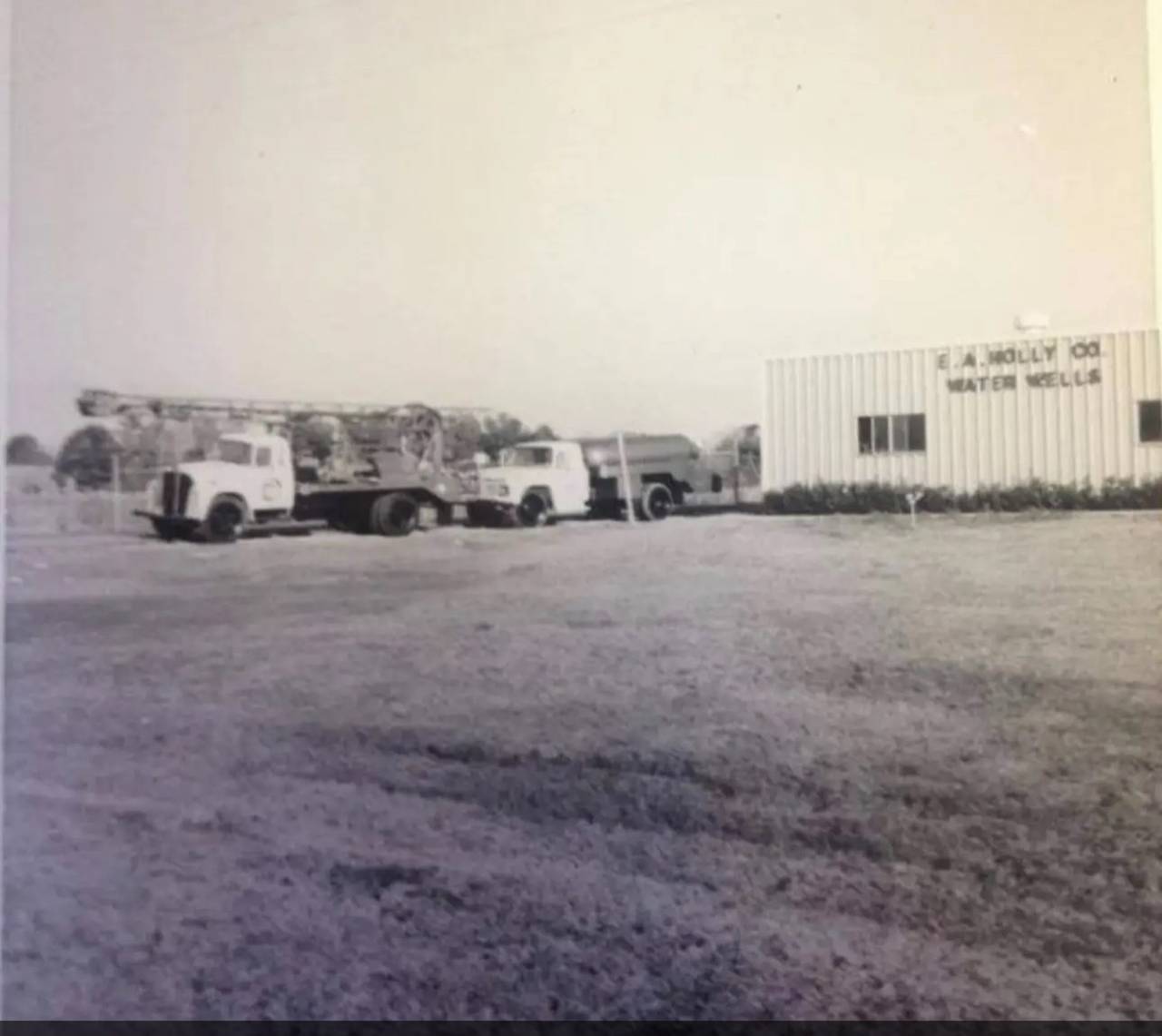 Historic photo of the original E.A. Holly Co. Water Wells shop and trucks