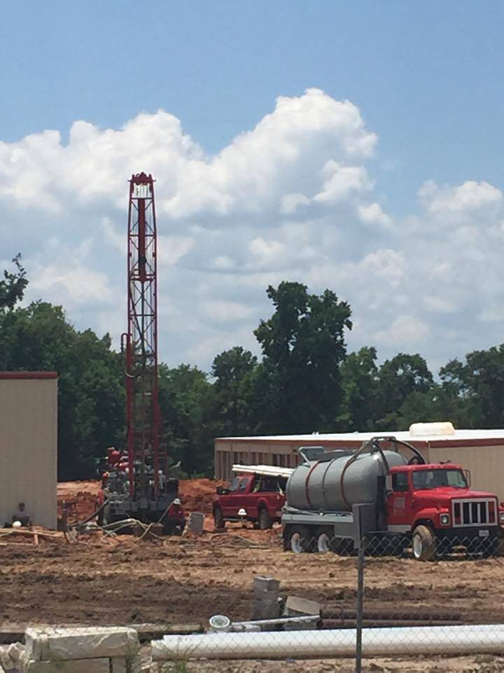 Holly Water Wells service truck at a completed residential water well site